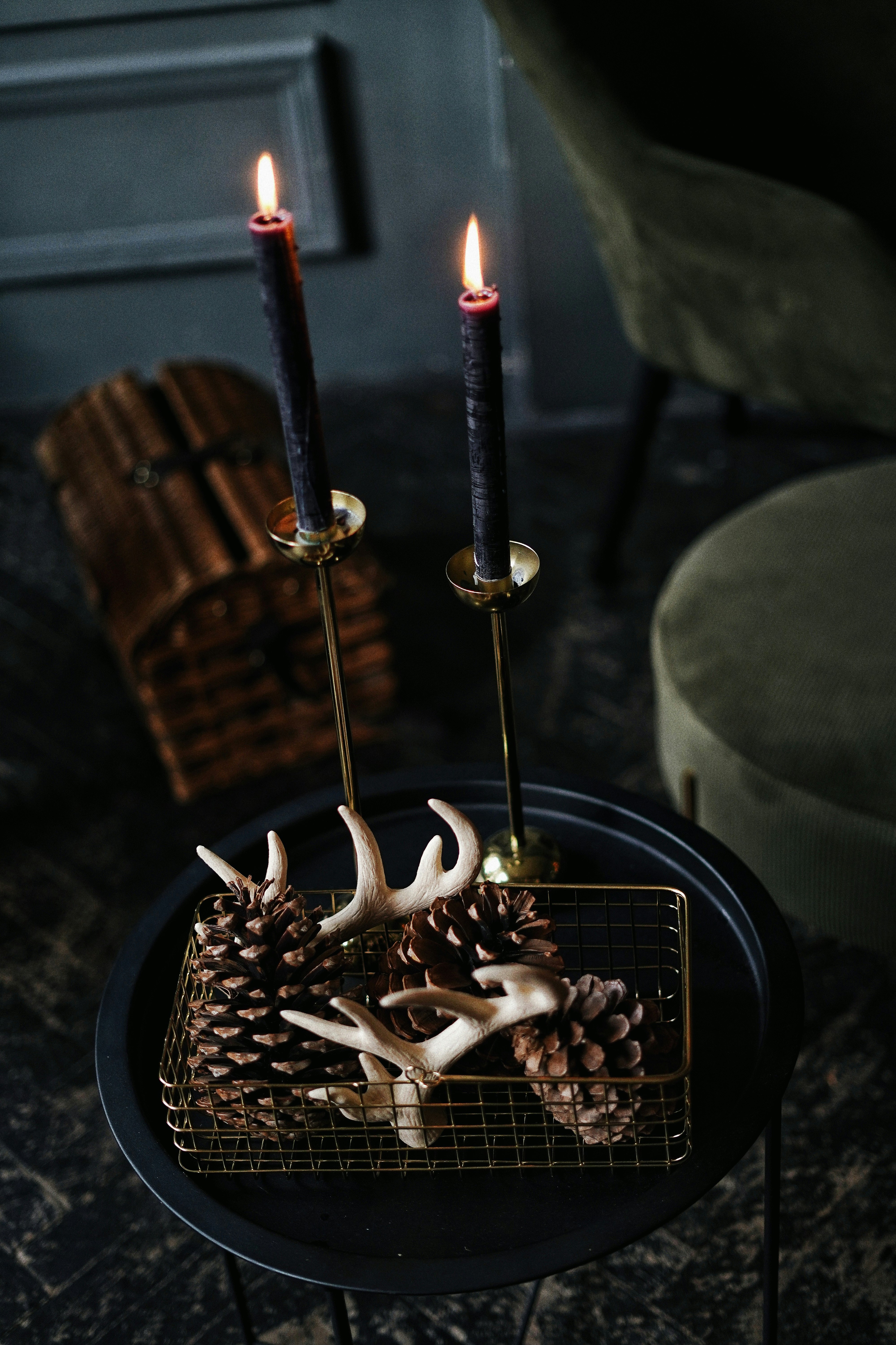 lighted candles on black metal candle holder